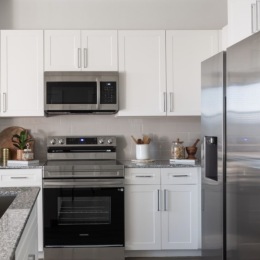 kitchen with ample counter-space, modern appliances and bright lighting
